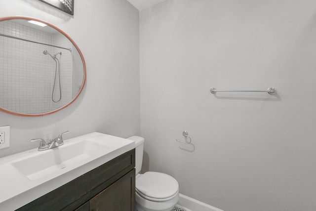 full bath featuring walk in shower, toilet, vanity, and baseboards