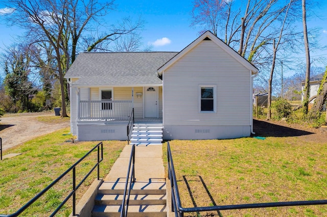 bungalow featuring crawl space, roof with shingles, covered porch, and a front yard