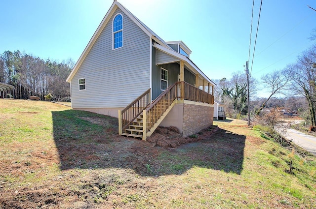 view of property exterior featuring stairs and a yard