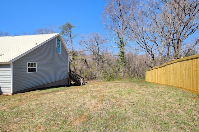 view of yard featuring stairs and fence