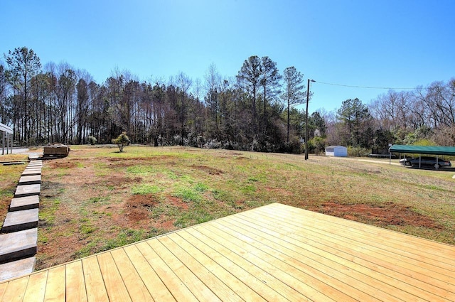 wooden terrace featuring a view of trees