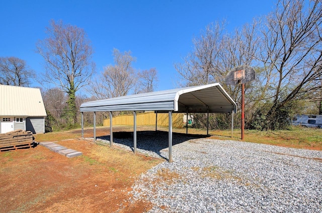 exterior space featuring a carport, an outbuilding, and driveway