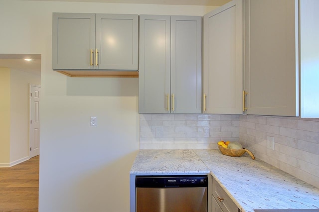 kitchen with backsplash, dishwasher, light wood-style flooring, and gray cabinets