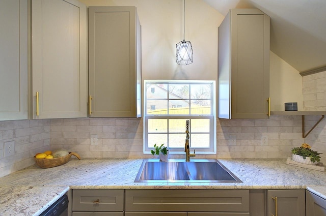 kitchen featuring gray cabinetry, a sink, tasteful backsplash, dishwasher, and vaulted ceiling