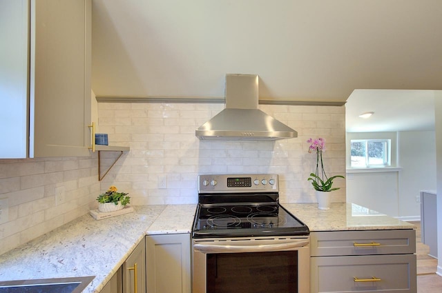 kitchen featuring gray cabinetry, island exhaust hood, electric stove, and light stone countertops