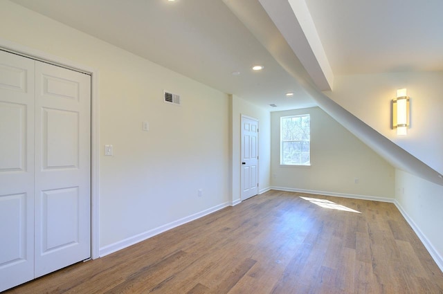 additional living space featuring visible vents, recessed lighting, baseboards, and wood finished floors