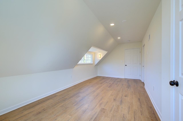 bonus room featuring visible vents, lofted ceiling, light wood-style flooring, recessed lighting, and baseboards