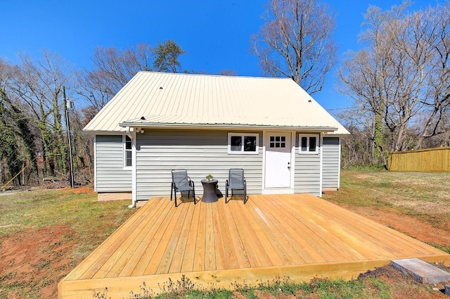 wooden terrace featuring a yard