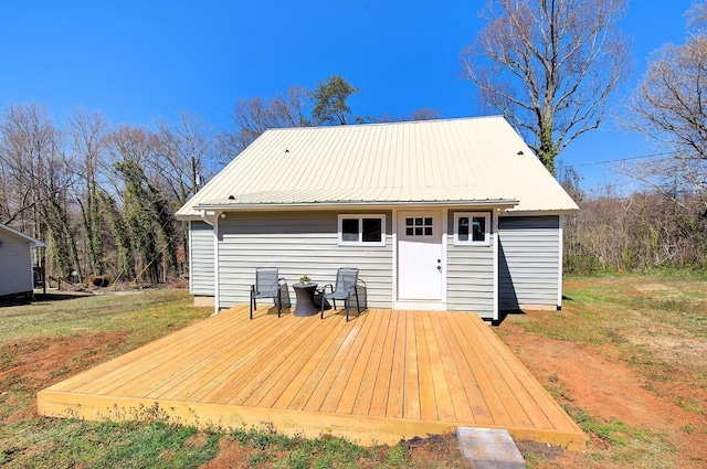 rear view of property with metal roof and a deck