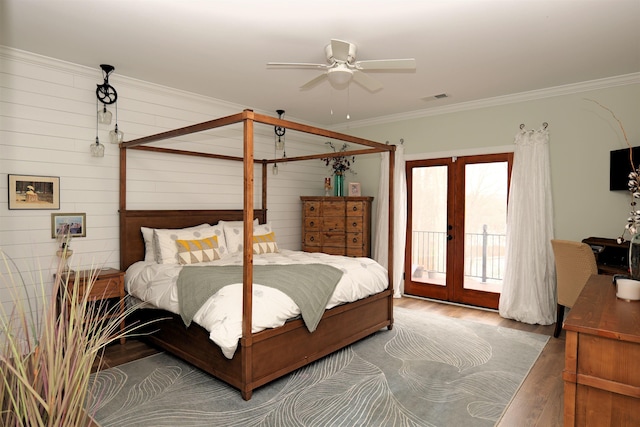 bedroom featuring wood finished floors, visible vents, french doors, crown molding, and access to outside