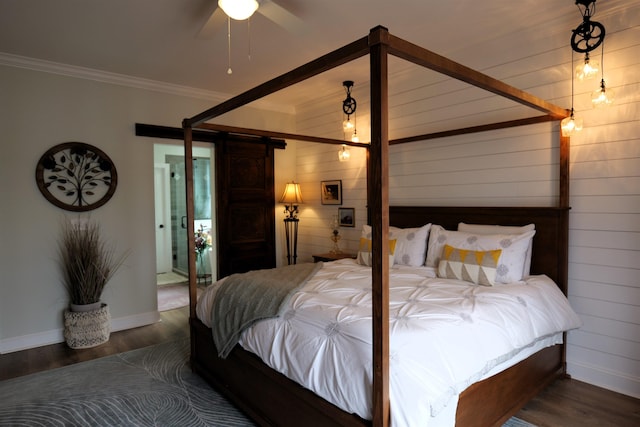 bedroom with crown molding, baseboards, and wood finished floors