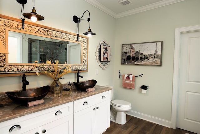 bathroom featuring visible vents, a shower stall, crown molding, and a sink