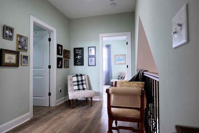 sitting room with dark wood finished floors and baseboards