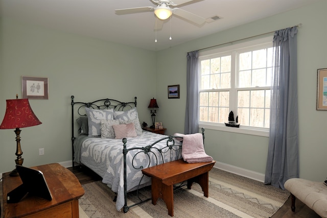 bedroom with light wood-style flooring, baseboards, visible vents, and ceiling fan