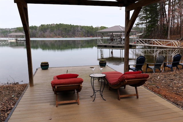 view of dock with a gazebo and a water view