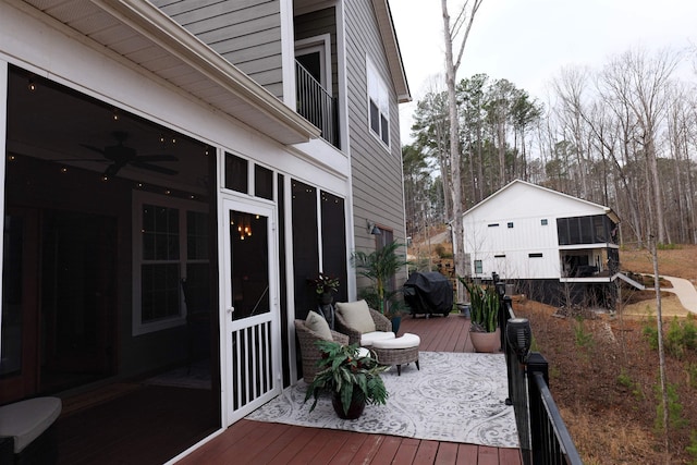 deck with a grill and a sunroom