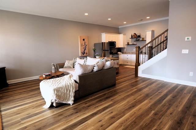 living area featuring dark wood finished floors, recessed lighting, crown molding, and stairs