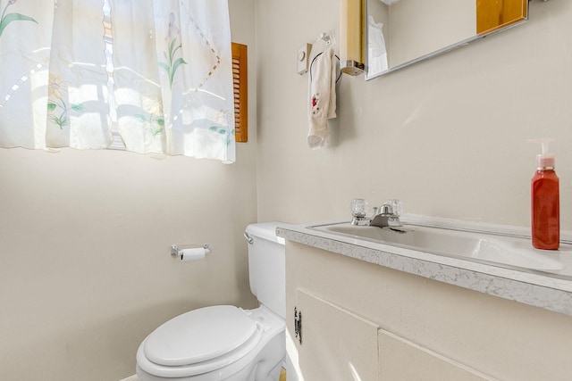 bathroom with toilet and vanity