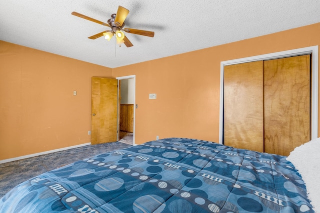 unfurnished bedroom with baseboards, carpet floors, a closet, a textured ceiling, and a ceiling fan