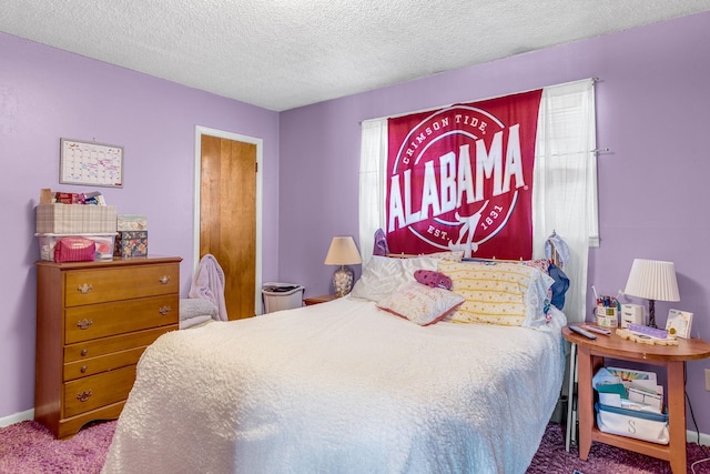 carpeted bedroom with baseboards and a textured ceiling