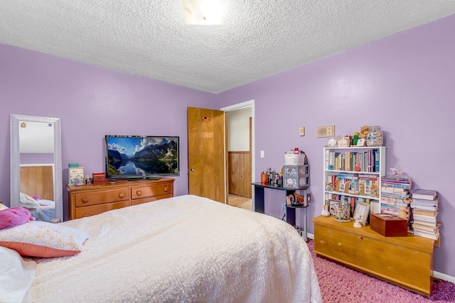 carpeted bedroom with a textured ceiling