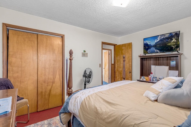 carpeted bedroom with a closet and a textured ceiling