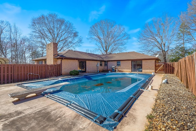 view of pool with a patio area, a fenced in pool, and a fenced backyard