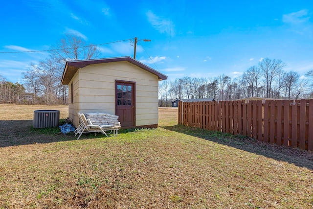 view of shed with central AC and fence