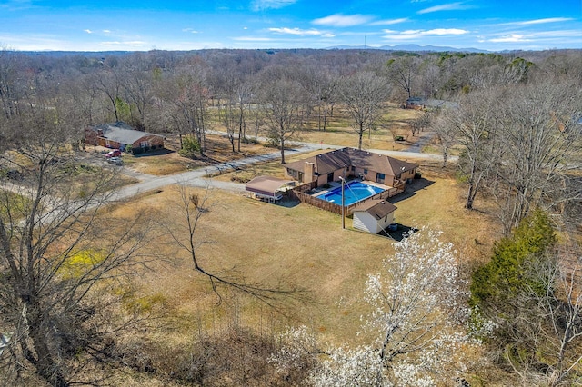 bird's eye view featuring a rural view and a wooded view