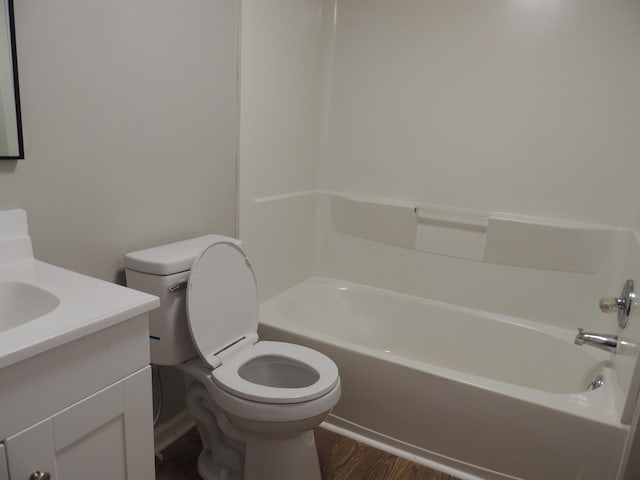 bathroom featuring vanity, bathing tub / shower combination, toilet, and wood finished floors