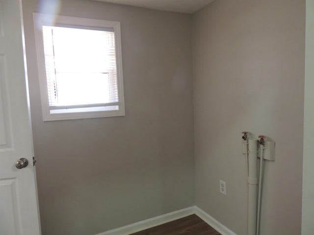 laundry room with laundry area, baseboards, and dark wood-style flooring