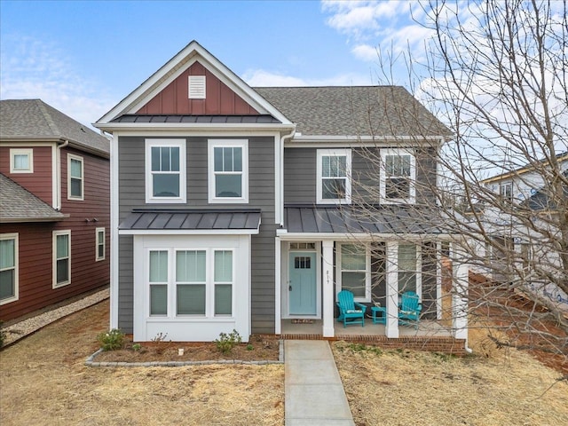 view of front of property with board and batten siding, a shingled roof, a porch, metal roof, and a standing seam roof