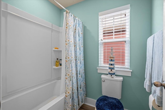 full bathroom with toilet, baseboards, and shower / bath combo