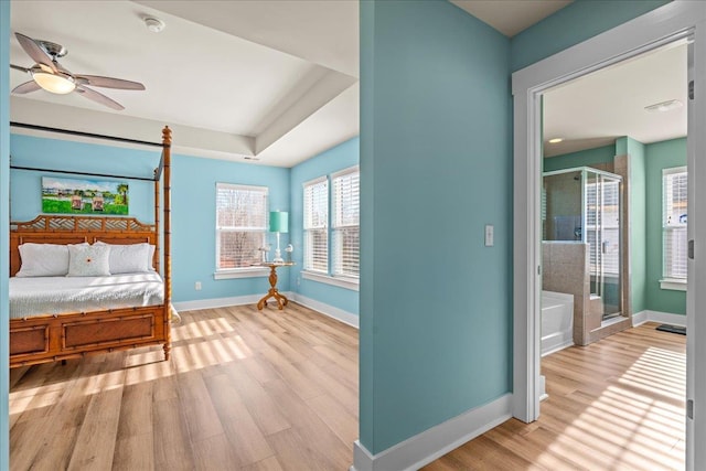 bedroom featuring access to exterior, wood finished floors, and baseboards