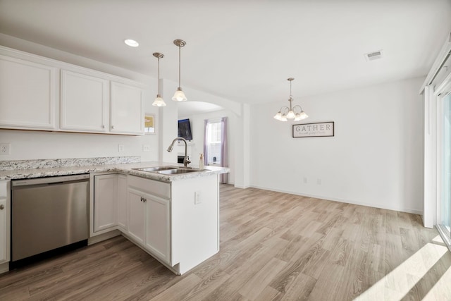 kitchen with a sink, stainless steel dishwasher, arched walkways, a peninsula, and white cabinets