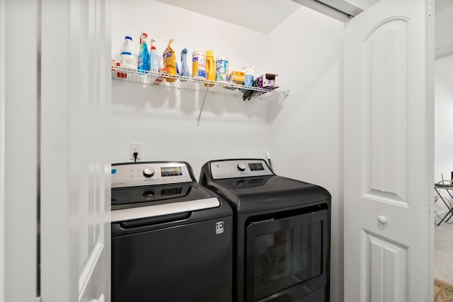 clothes washing area featuring laundry area and washing machine and dryer