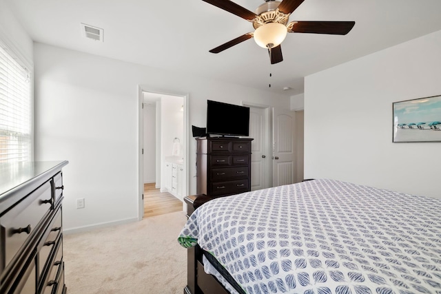 bedroom with a ceiling fan, light colored carpet, visible vents, and baseboards