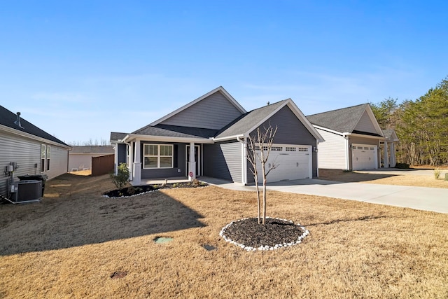 view of front facade featuring a shingled roof, central AC, a front yard, driveway, and an attached garage