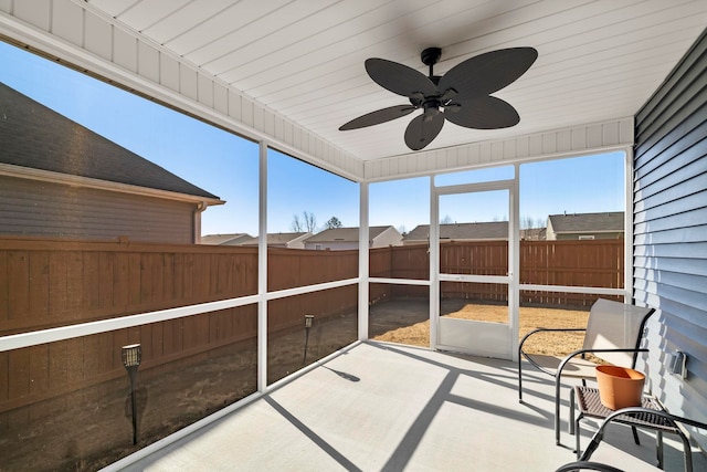 unfurnished sunroom featuring a healthy amount of sunlight and a ceiling fan