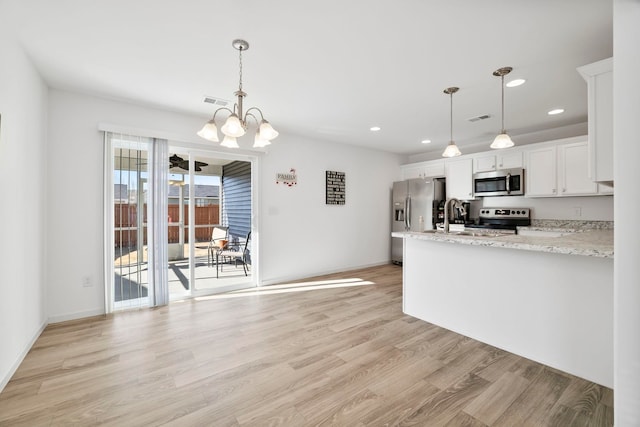 kitchen featuring visible vents, light wood-type flooring, a notable chandelier, white cabinets, and stainless steel appliances