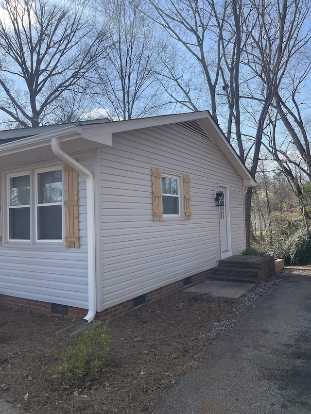 view of side of property with crawl space