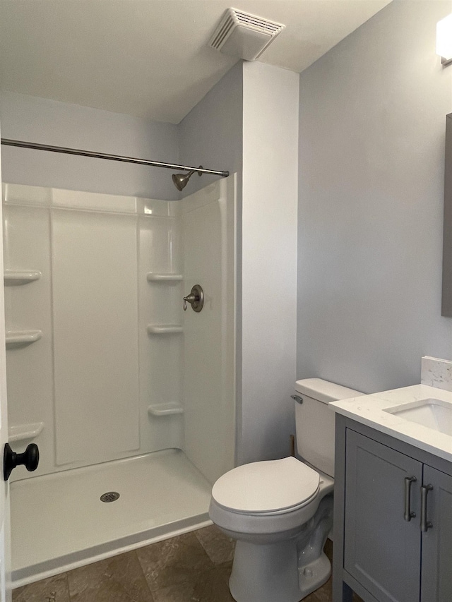 bathroom with a shower, visible vents, toilet, and vanity