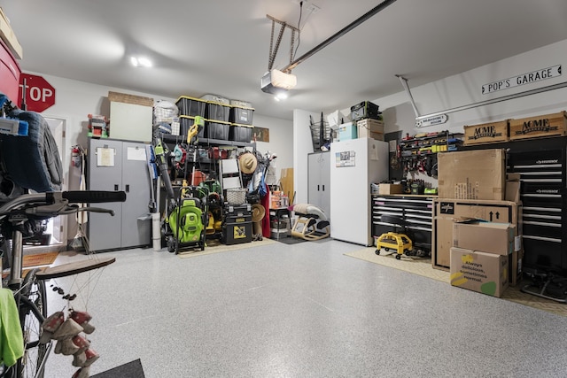 garage with a workshop area and a garage door opener