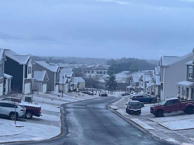 view of road featuring sidewalks, curbs, and a residential view