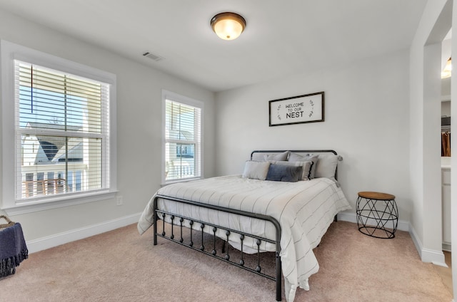 bedroom with visible vents, baseboards, and carpet