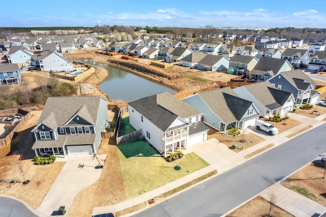 drone / aerial view with a residential view and a water view