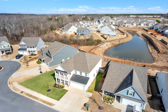 birds eye view of property featuring a residential view and a water view