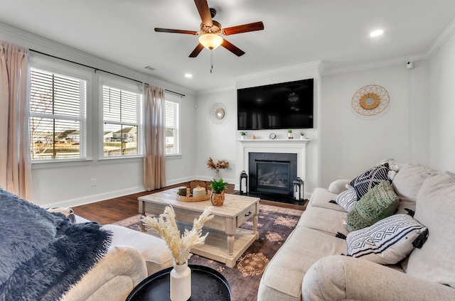 living area with a ceiling fan, dark wood-type flooring, baseboards, and ornamental molding