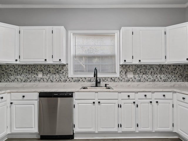 kitchen with tasteful backsplash, ornamental molding, stainless steel dishwasher, white cabinets, and a sink