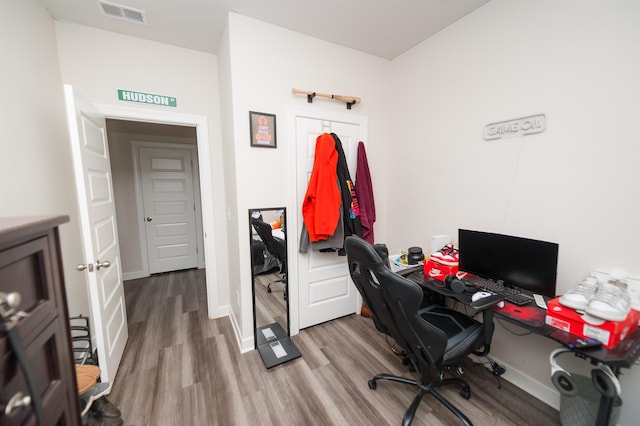 office area featuring wood finished floors, visible vents, and baseboards